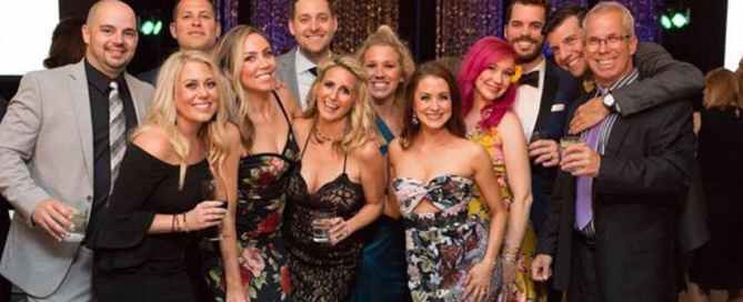 Megan Hornsby (front row second from left) celebrates with clients and friends.