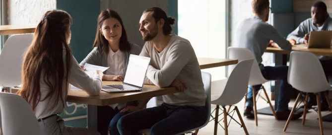 Three people meeting at a table