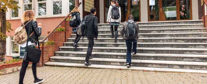Students walking up stairs to school